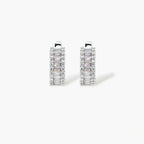 White gold plated necklace with vertical cubic zirconia pendant and matching hoop earrings on neutral background