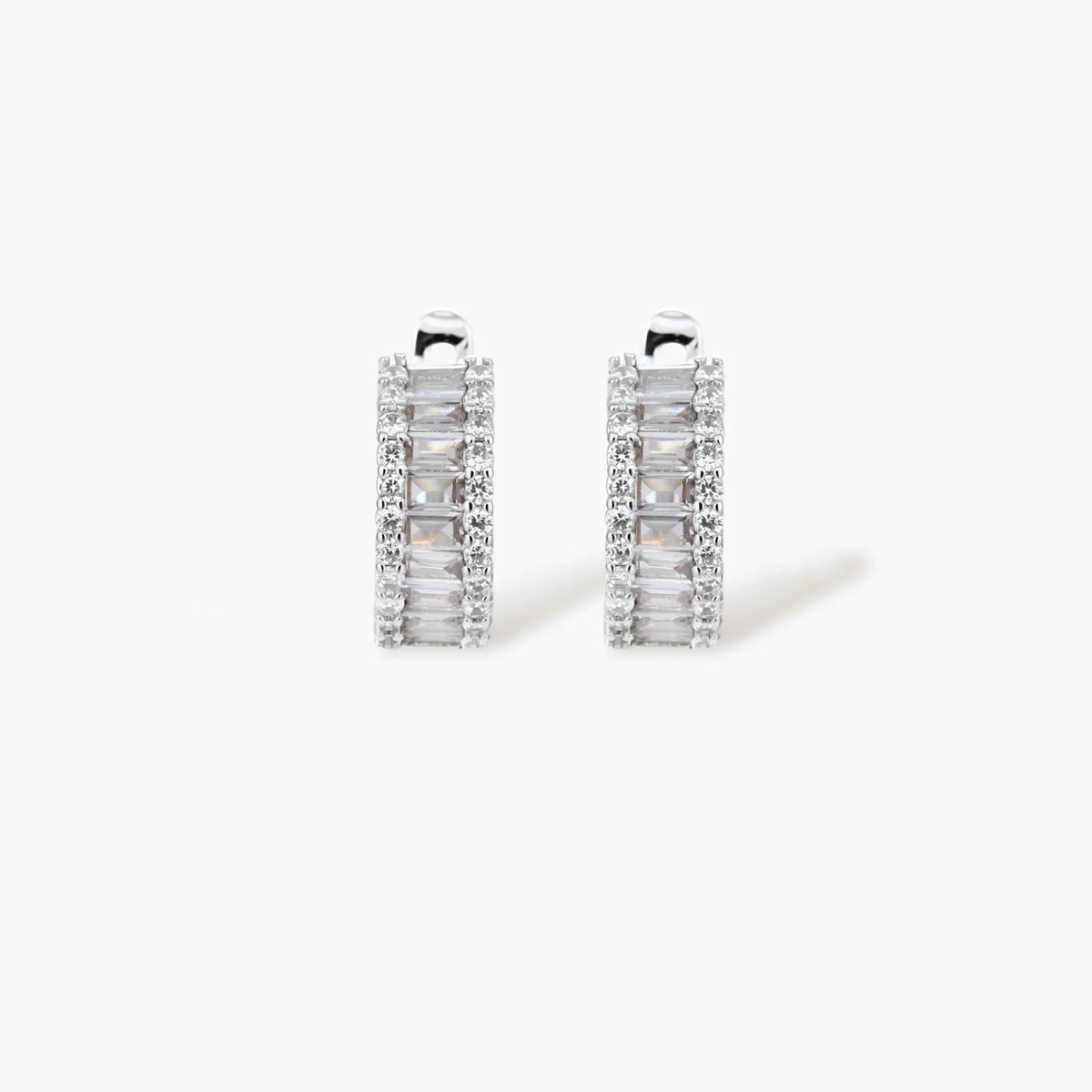White gold plated necklace with vertical cubic zirconia pendant and matching hoop earrings on neutral background