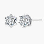 Close-up of round brilliant-cut moissanite stud earrings in 6-prong sterling silver settings showing exceptional sparkle