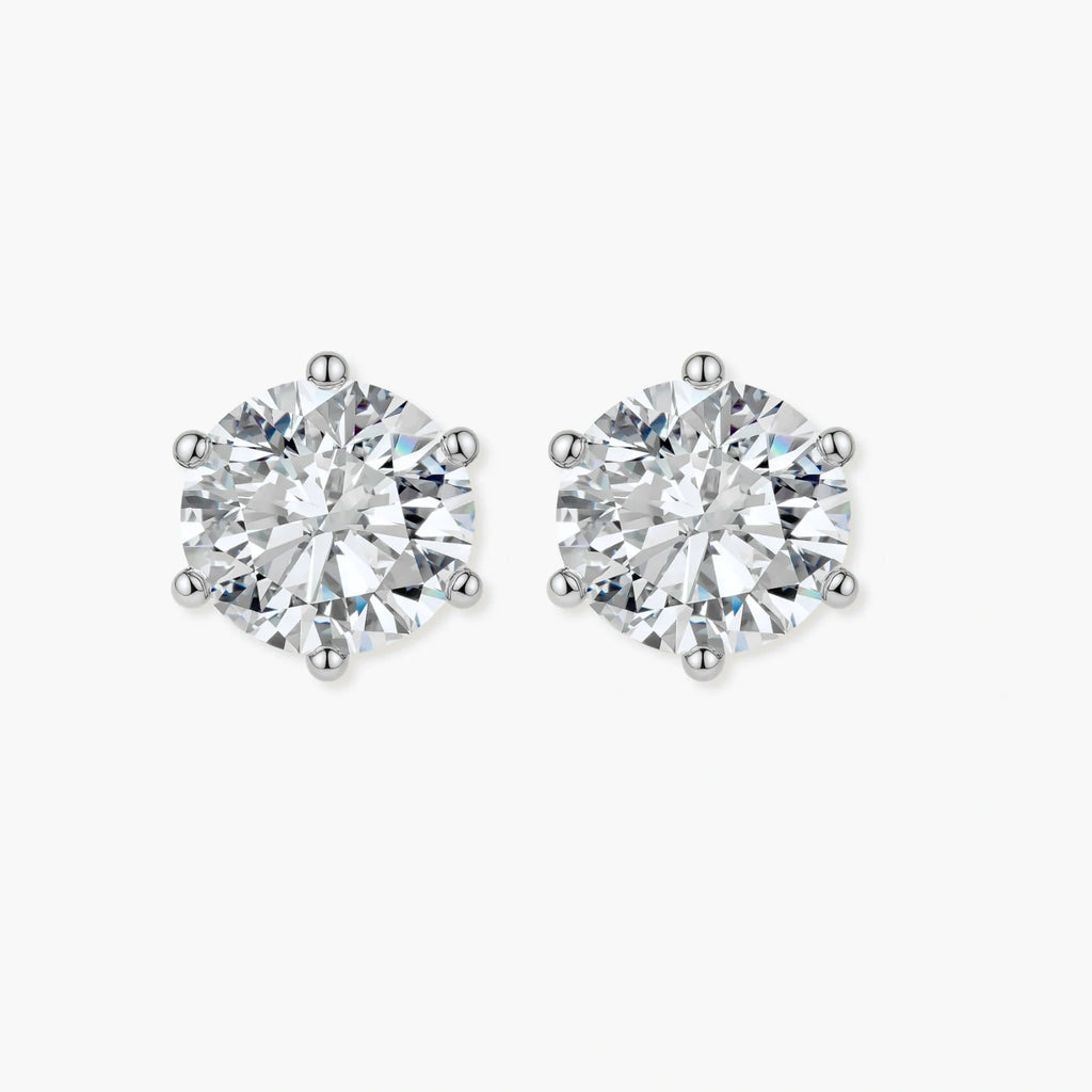 Close-up of round brilliant-cut moissanite stud earrings in 6-prong sterling silver settings showing exceptional sparkle