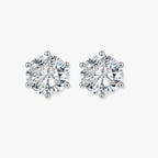 Close-up of round brilliant-cut moissanite stud earrings in 6-prong sterling silver settings showing exceptional sparkle