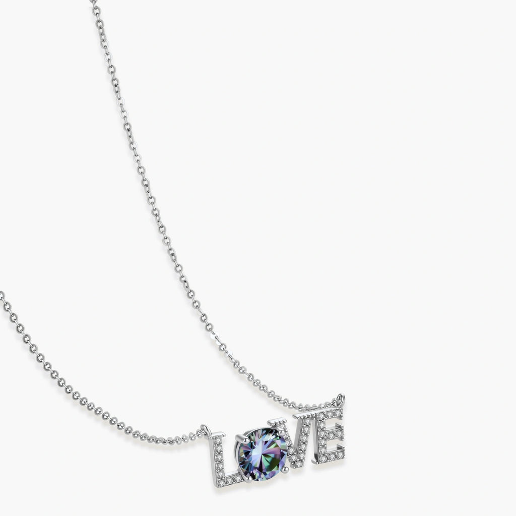 Sterling silver LOVE necklace with brilliant moissanite center stone and pavé details on neutral background.
