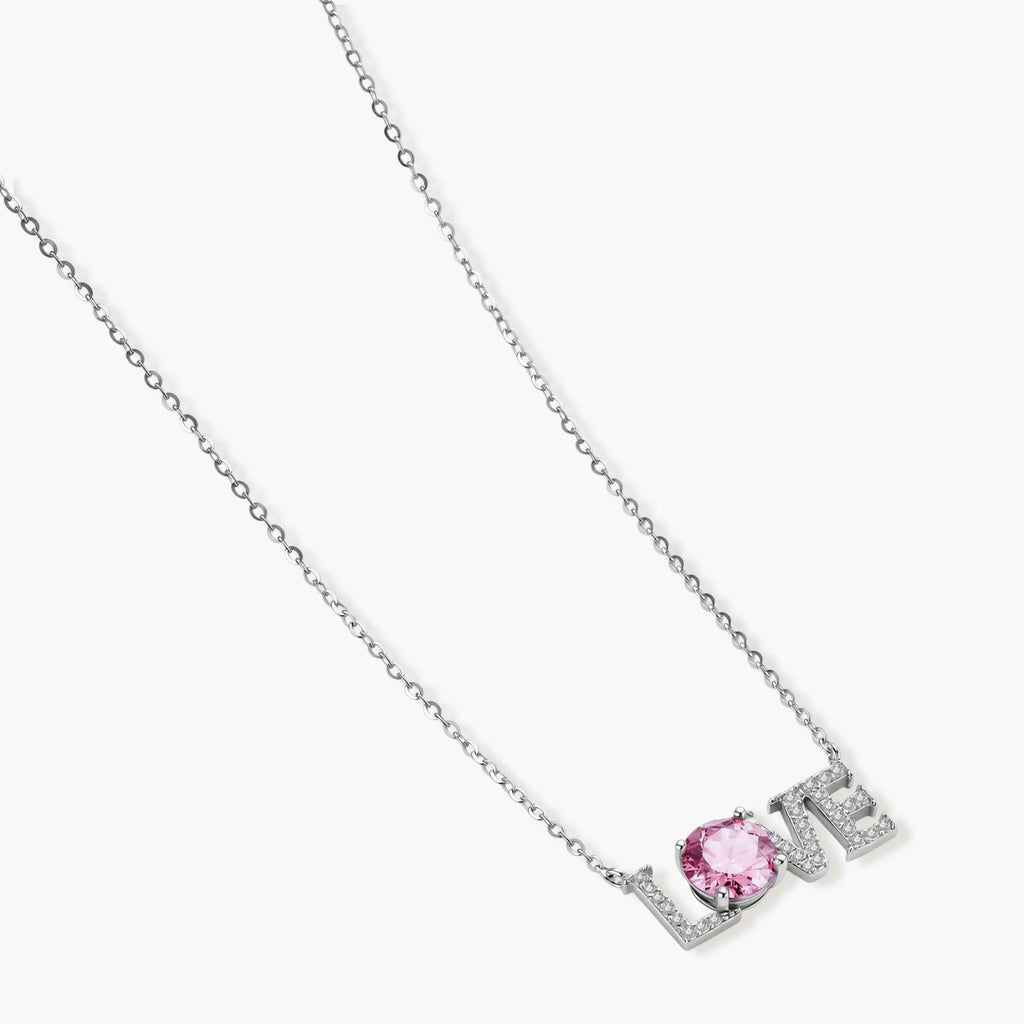 Sterling silver LOVE necklace with pink moissanite stone replacing the O, featuring crystal-set letters on delicate chain.