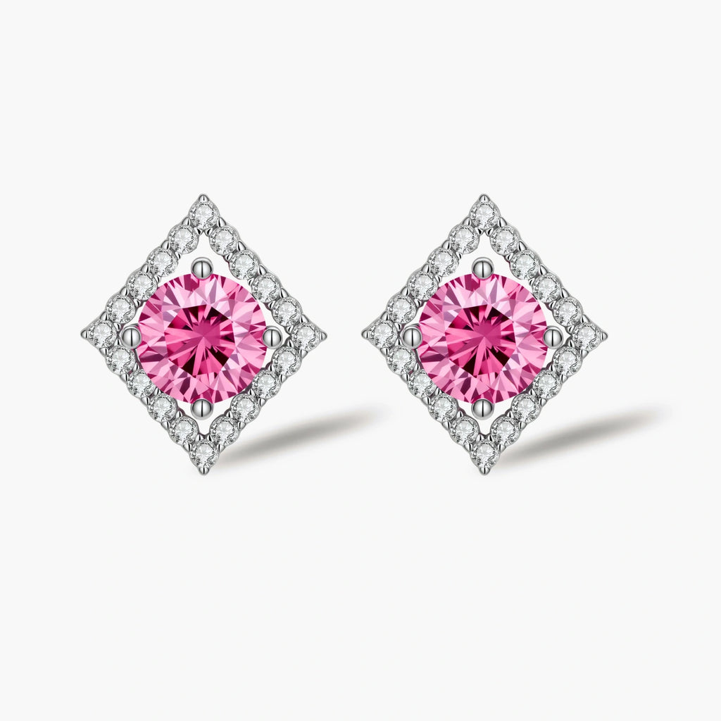Sterling silver diamond-shaped stud earrings with pink moissanite center stones and crystal halo setting on white background
