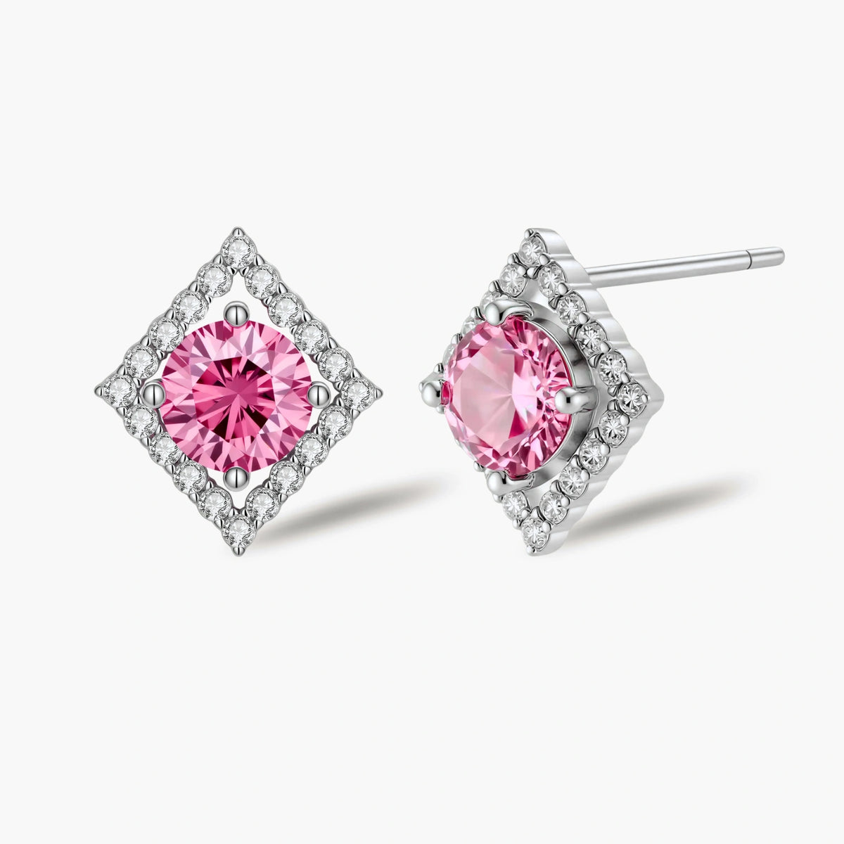 Sterling silver diamond-shaped stud earrings with pink moissanite center stones and crystal halo setting on white background