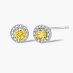 Dainty sterling silver stud earrings with yellow moissanite center stones surrounded by white halo stones