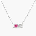 Sterling silver LOVE necklace with pink moissanite stone replacing the O, featuring crystal-set letters on delicate chain.
