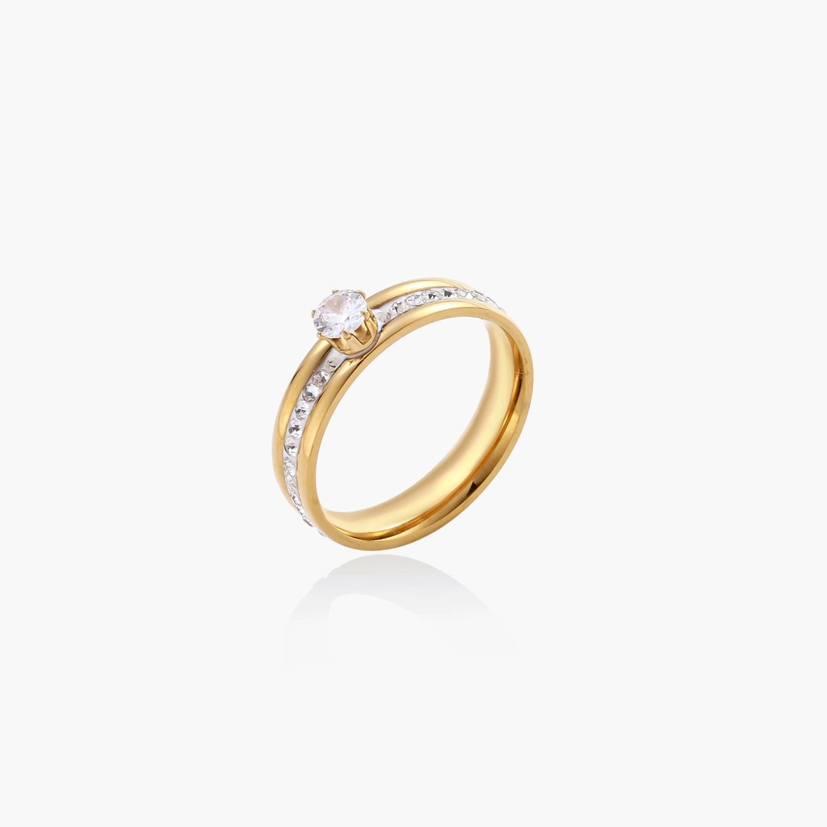 Gold-plated double-band ring with center rhinestone solitaire and channel-set stones on white background