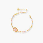 Delicate beaded bracelet with pastel rose quartz, pearls, and pink cushion-cut centerpiece in gold-plated setting