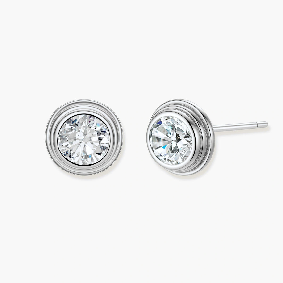Close-up of sterling silver stud earrings featuring concentric circular frames with brilliant moissanite centers