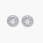 Close-up of sterling silver stud earrings featuring concentric circular frames with brilliant moissanite centers