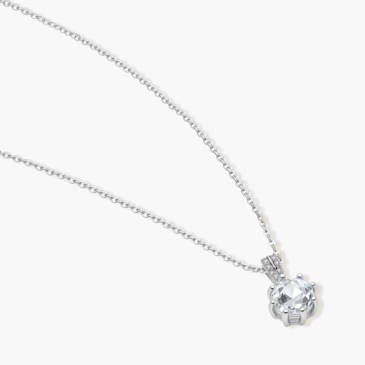 Platinum-plated sterling silver necklace with round clear crystal pendant and decorative bail on neutral background.