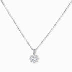 Platinum-plated sterling silver necklace with round clear crystal pendant and decorative bail on neutral background.