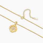 Gold-plated flower pendant necklace with brushed finish, open-work center, marquise CZ stones on wheat chain, S925 stamp.