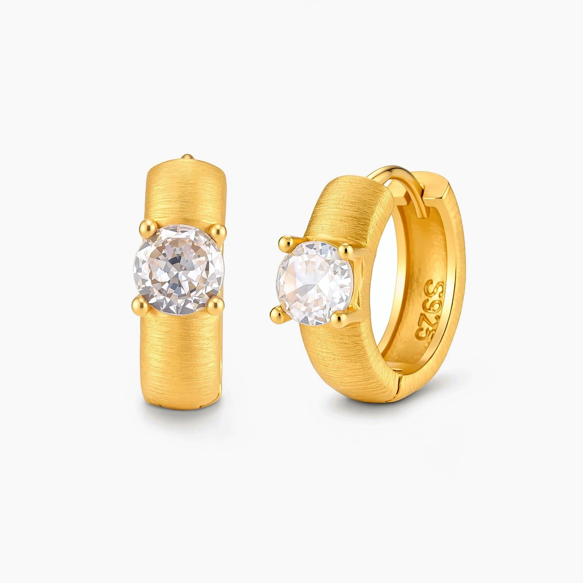 18K gold-plated 925 silver huggie hoops with brushed finish and prong-set round CZ solitaire, stamped S925 inside.