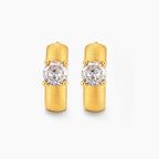 18K gold-plated 925 silver huggie hoops with brushed finish and prong-set round CZ solitaire, stamped S925 inside.