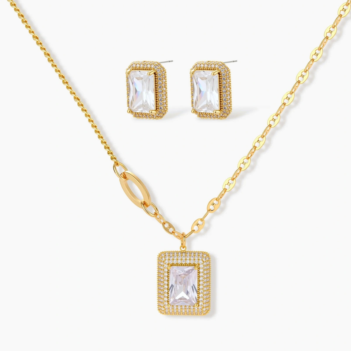 Gold-plated jewelry set with rectangular cubic zirconia stones in pave halo settings on cream background