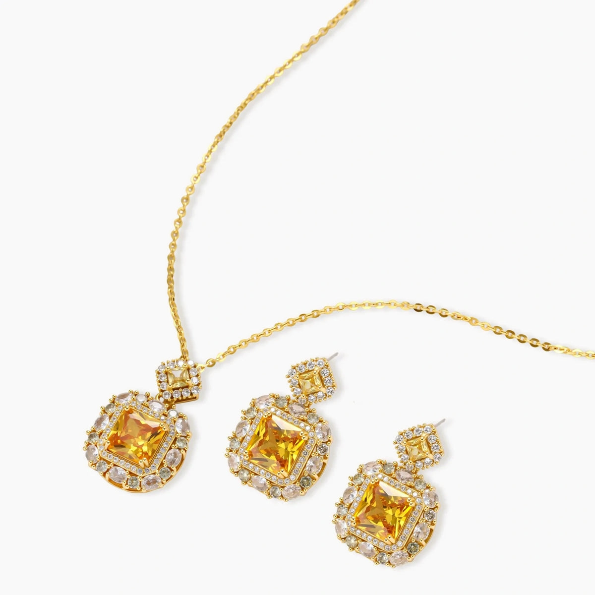 14K gold-plated jewelry set featuring square-cut cubic zirconia stones in ornate layered settings on white background.