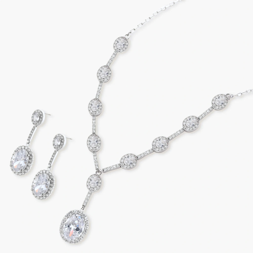 Elegant white gold plated jewelry set with oval cubic zirconia stones in halo settings, featuring Y-necklace and drop earrings.