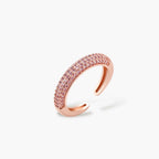 Rose gold pavé zirconia bar necklace, hoop earrings, and open ring set with pink stones on cream background.