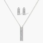 White gold plated necklace with vertical cubic zirconia pendant and matching hoop earrings on neutral background