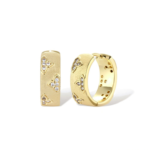 Gold-plated hoop earrings with textured surface and raised floral motifs set with clear zirconia stones on cream background.